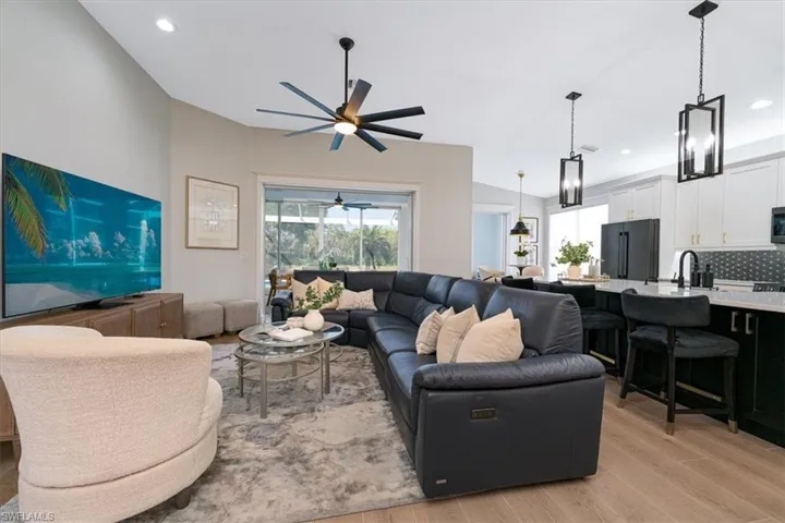 Living area with recessed lighting, light wood-style flooring, and a ceiling fan