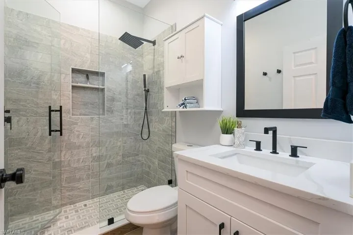 Full bathroom featuring vanity and a stall shower