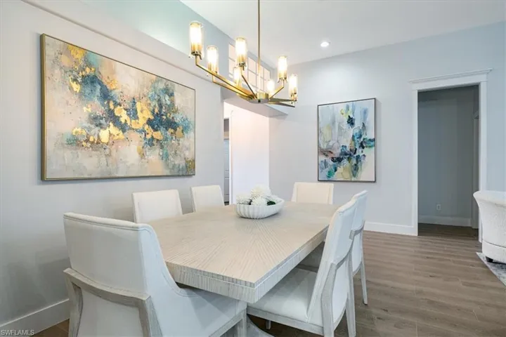 Dining room with wood finished floors and suspended lighting