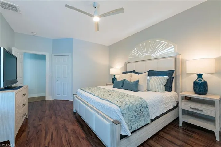 Bedroom with dark wood finished floors and a ceiling fan