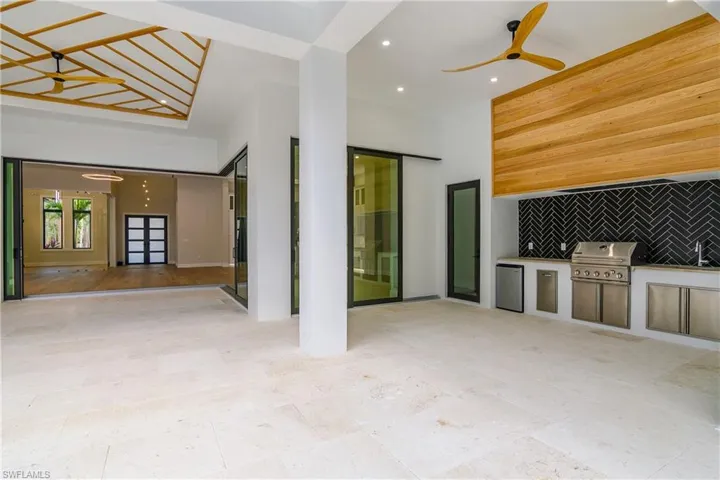 Unfurnished living room featuring recessed lighting, a high ceiling, and ceiling fan