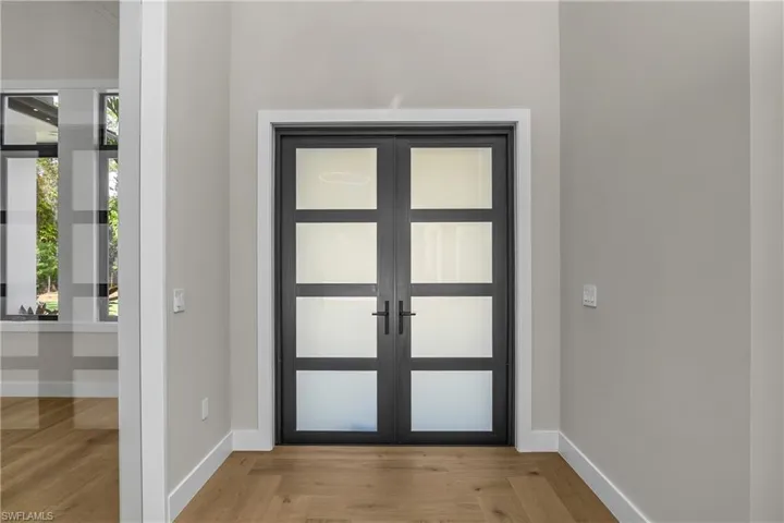 Entrance foyer with french doors and wood finished floors