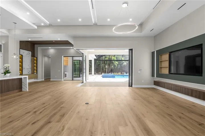 Unfurnished living room featuring a sunroom and light wood finished floors