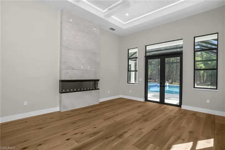 Unfurnished living room with french doors and wood finished floors