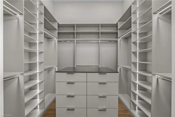 Walk in closet featuring dark wood-style flooring