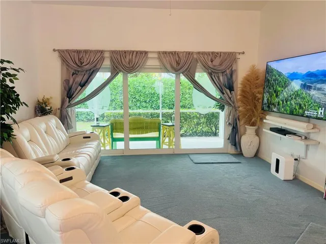 Carpeted living room with healthy amount of natural light