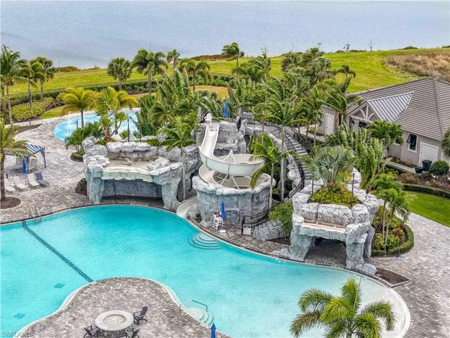 Community pool featuring a patio and a water slide