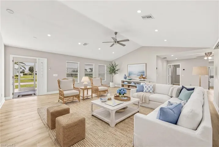 Living room with ceiling fan, light wood finished floors, and recessed lighting