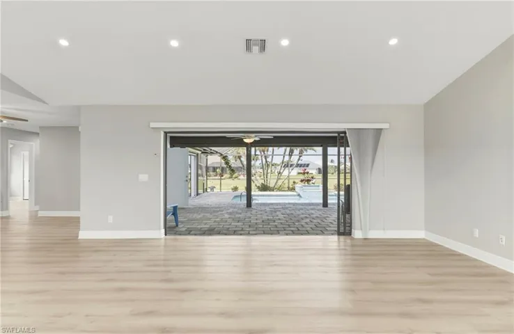 Empty room featuring ceiling fan, light wood-type flooring, and recessed lighting
