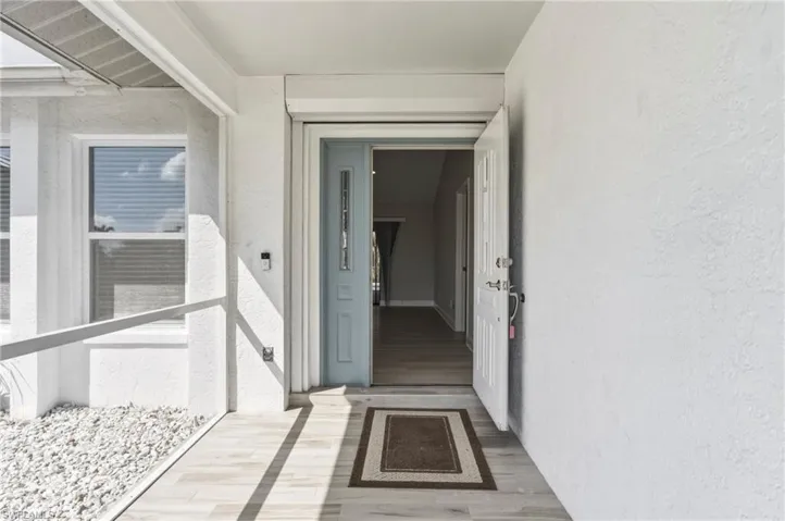 Entrance to property featuring stucco siding