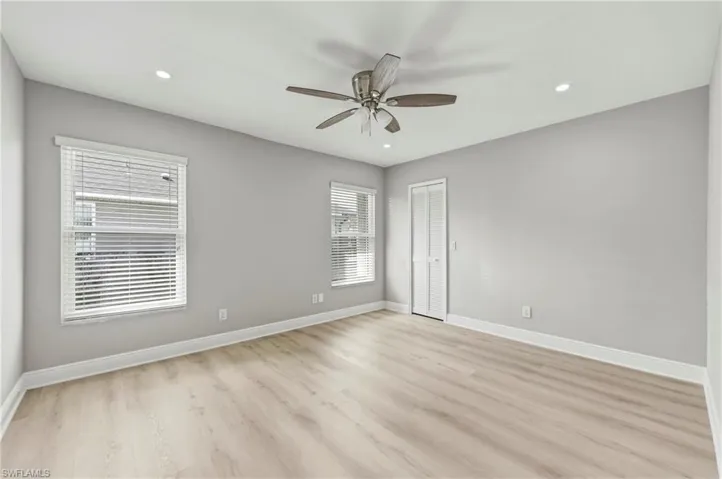 Unfurnished bedroom featuring light wood-type flooring, ceiling fan, recessed lighting, and a closet