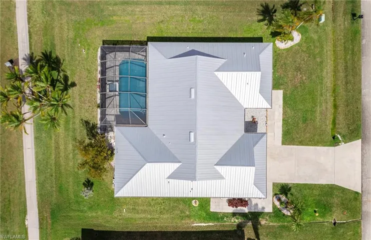 Aerial view of property and surrounding area featuring a pool