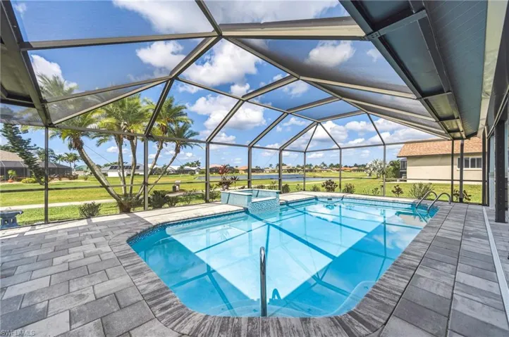 Integrated pool / spa featuring a sunroom, a lanai, a patio area, a yard, and a residential view