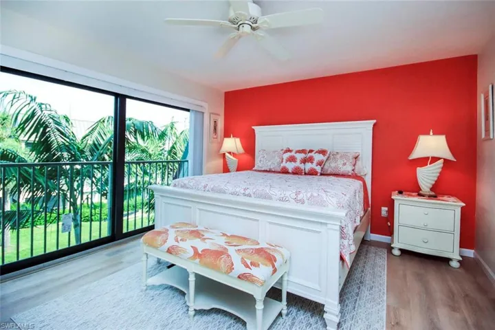 Bedroom with access to exterior, wood finished floors, and ceiling fan