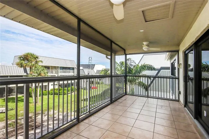 Balcony featuring ceiling fan and a sunroom
