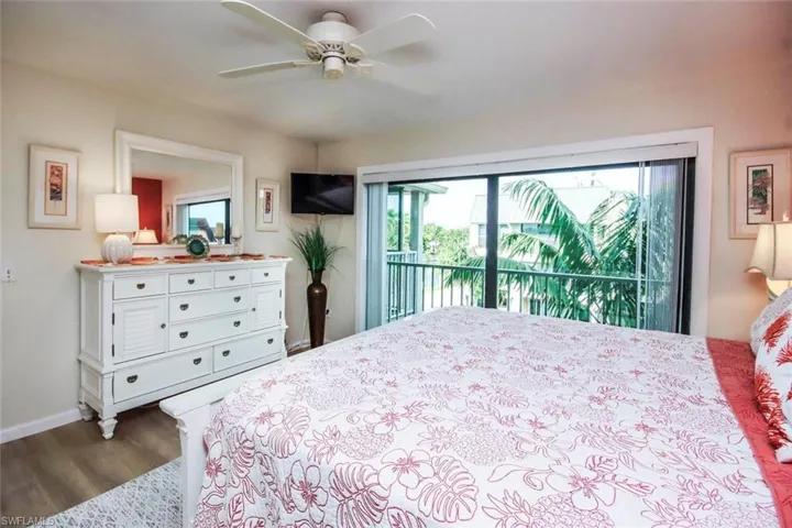 Bedroom with access to outside, dark wood finished floors, and ceiling fan