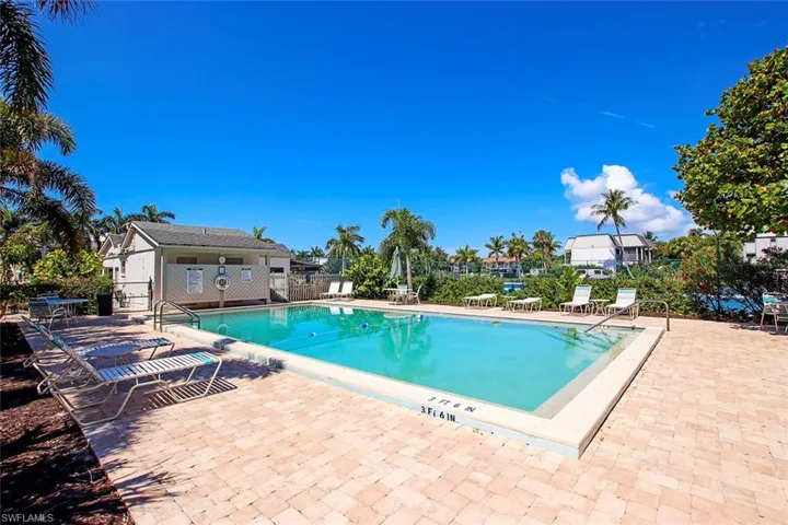 Community pool with a patio