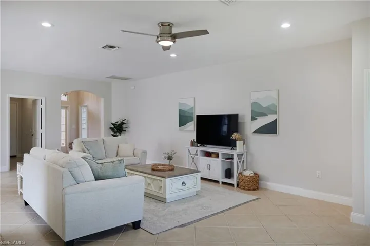 Spacious main living area featuring tile flooring, neutral wall tones, recessed lighting, and a ceiling fan