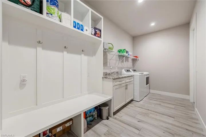 Large laundry room with drop zone and storage