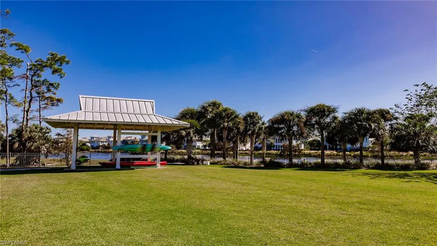 Surrounding community with a water view, a lawn, and a gazebo