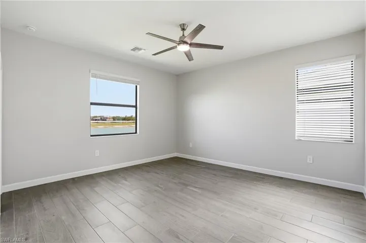 Spare room featuring ceiling fan and light wood-type flooring