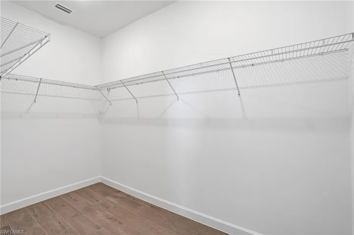 Walk in closet featuring wood finished floors