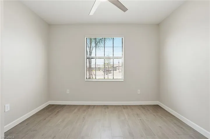 Spare room featuring light wood-type flooring and ceiling fan