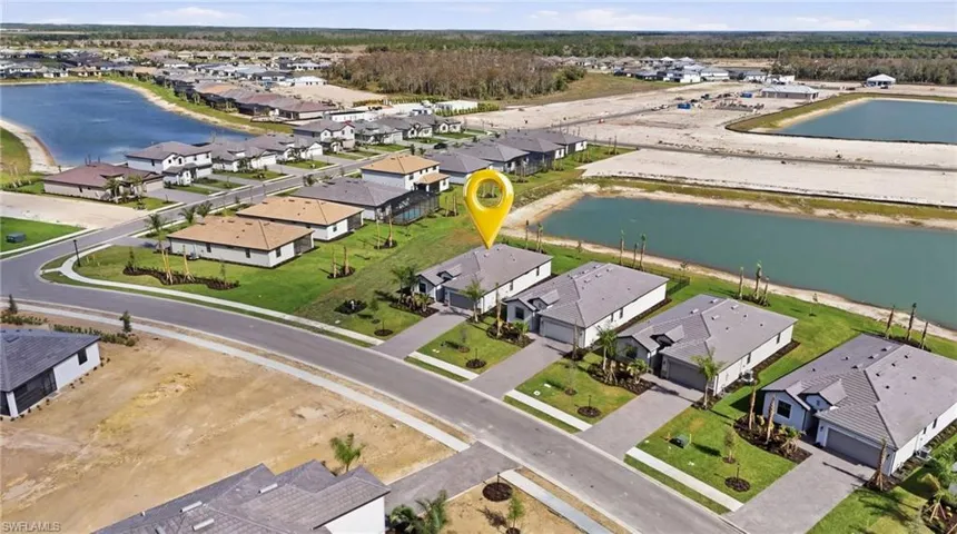 Aerial view of property's location featuring a large body of water and nearby suburban area