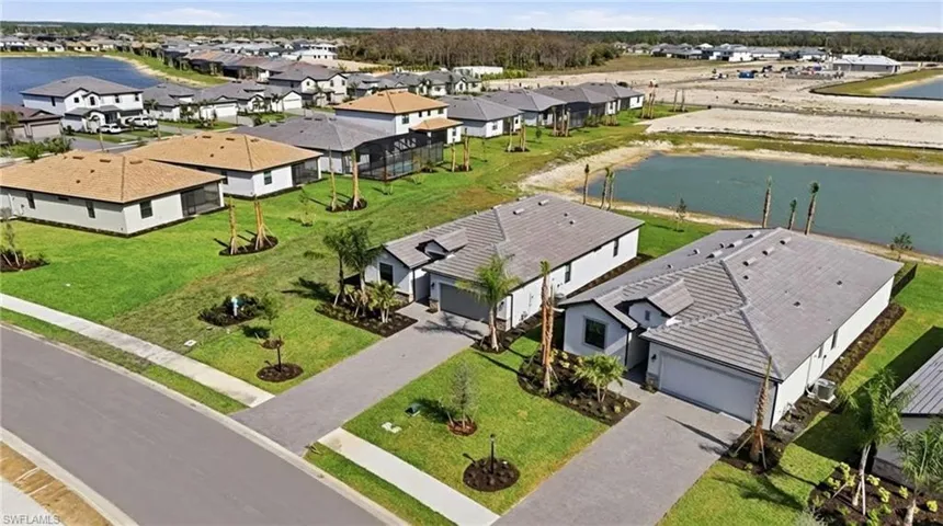 Aerial view of residential area featuring a nearby body of water