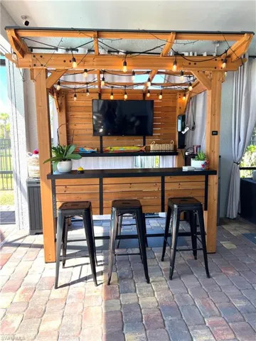 Bar area featuring brick flooring and wood walls
