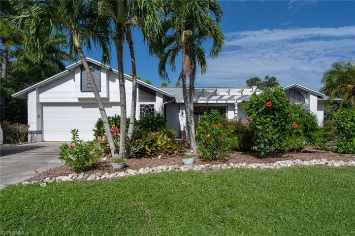 Single story home featuring an attached 2 car garage and a front yard.