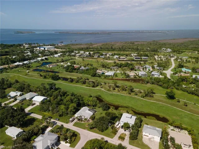Birds eye view of property with a water view
