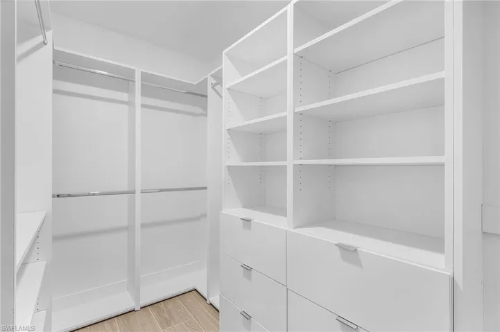 Spacious closet featuring light hardwood / wood-style flooring