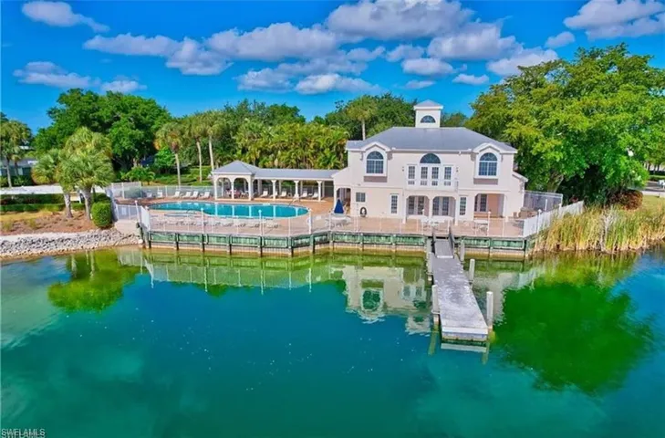 Back of property with a gazebo and a water view