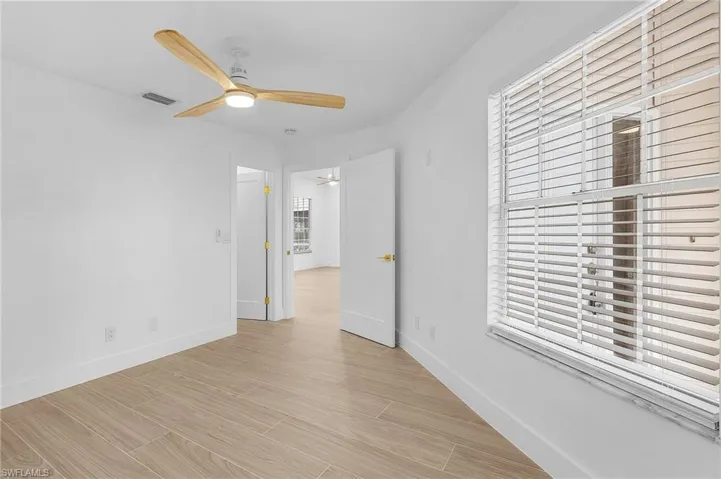 Spare room featuring plenty of natural light and ceiling fan