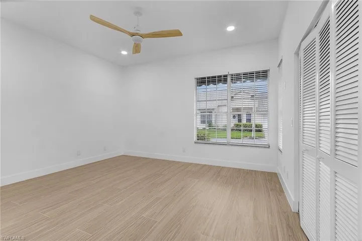 Unfurnished bedroom featuring ceiling fan and light wood-type flooring