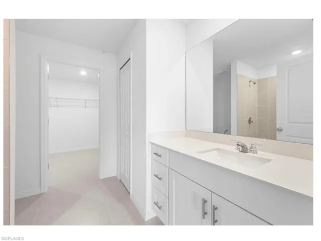 Private primary bathroom with dual vanity.