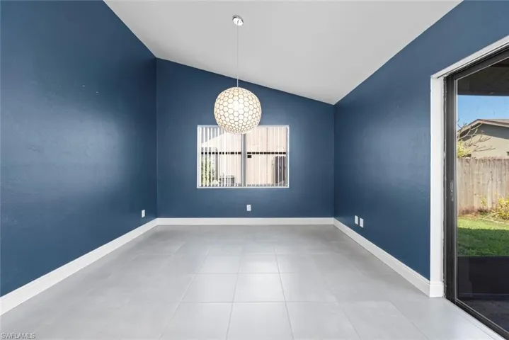 Empty room with vaulted ceiling