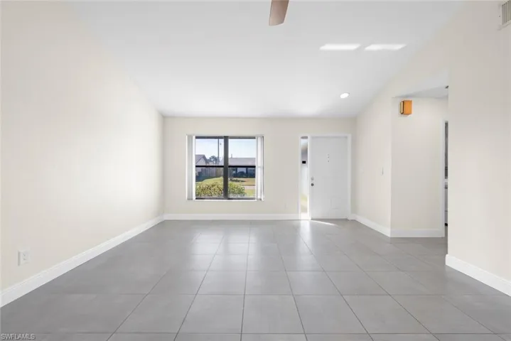 Spare room featuring light tile patterned floors and ceiling fan