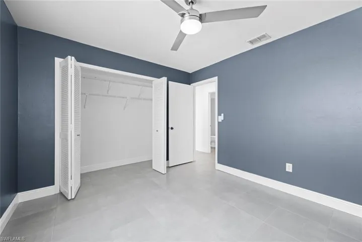 Unfurnished bedroom featuring ceiling fan and a closet