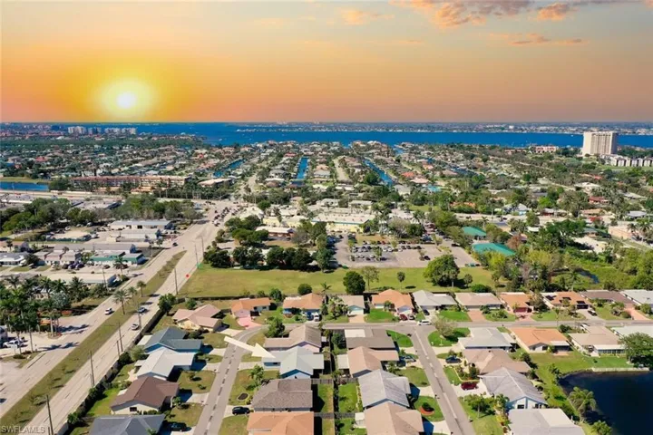 Aerial view at dusk featuring a water view