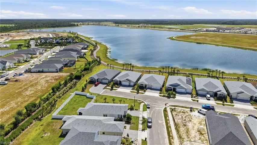 Lakefront community with newly constructed single-story residences featuring attached garages