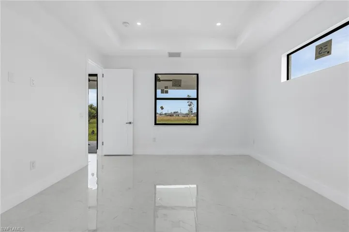 Empty room featuring a tray ceiling