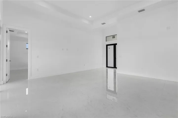 Spare room featuring a tray ceiling