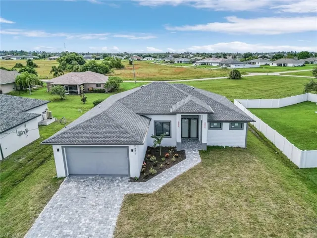 View of front of house with a front yard and a garage