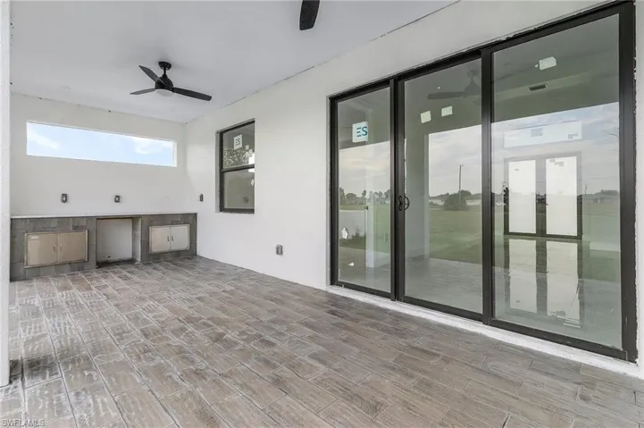 View of patio featuring ceiling fan and an outdoor kitchen