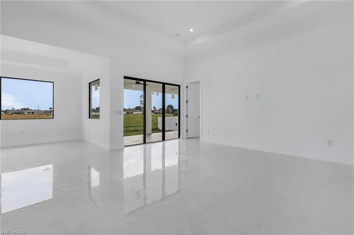 Unfurnished room featuring a towering ceiling