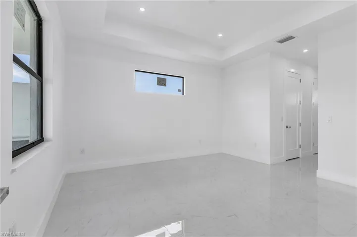 Empty room featuring a raised ceiling
