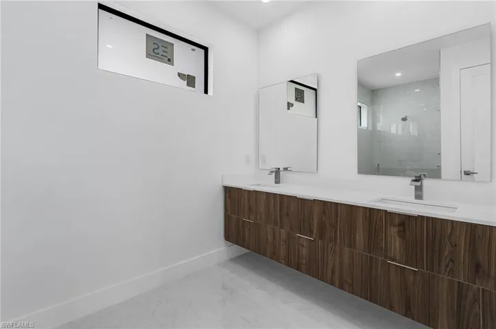 Bathroom with a tile shower and vanity