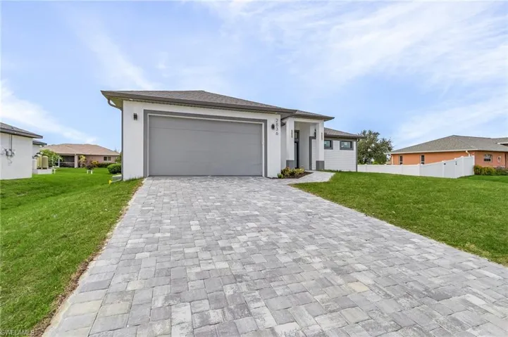 View of front of home featuring a front lawn and a garage
